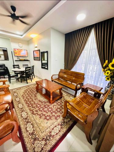 a living room with a couch and a table at Siti homestay kota bharu in Kota Bharu
