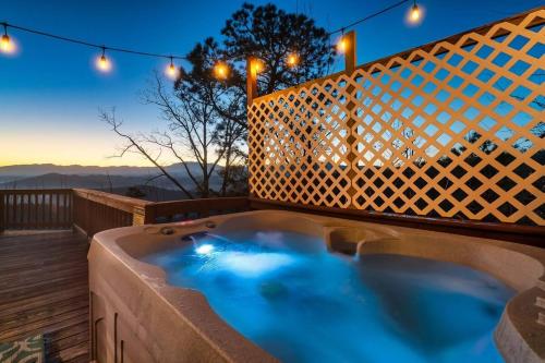a hot tub on a deck at night with lights at Heavenly Views, Hot Tub, Short Drive to Fun in Sevierville