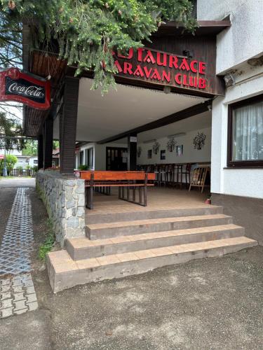 a restaurant with a bench in front of a building at Solo tábořiště, kemp u vody, Nová Živohošť in Křečovice