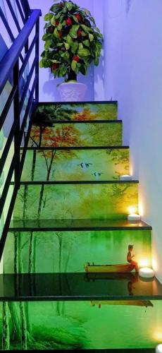 a set of stairs with a person sitting on a bench at Hoàng Nga 2 Homestay in Phan Thiet