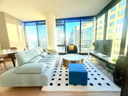 a living room with a couch and a table at Sydney CBD New 2 bedroom Condo with amazing view Pool Gym 2 in Sydney