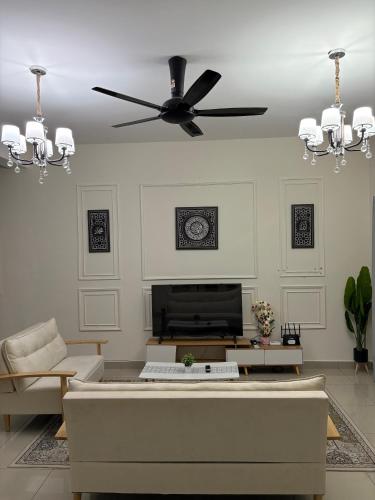 a living room with a ceiling fan and a couch at AFA Home KKB in Kuala Kubu Baharu