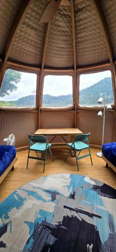a room with a table and chairs in a tent at Fuji Dome Glamping in Fujikawaguchiko
