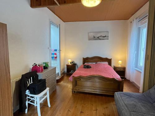 a bedroom with a bed and a chair in it at Maison de ville au Croisic avec WIFI et animaux admis - 4 personnes - FR-1-843-6 in Le Croisic