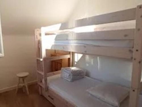 a wooden bunk bed in a room with a stool at Maison proche plages Le Croisic, parking inclus - FR-1-843-14 in Le Croisic