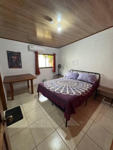 a bedroom with a bed and a wooden ceiling at Casa Nova at La Escapadita in Esterillos