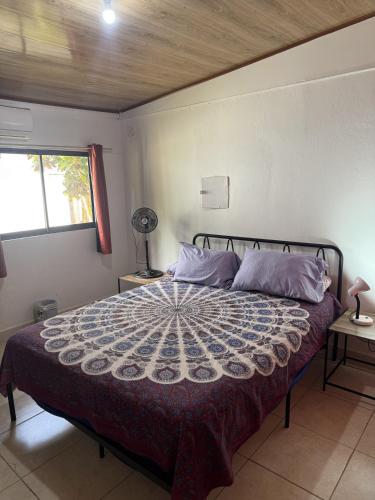 a bedroom with a large bed in a room at Casa Nova at La Escapadita in Esterillos