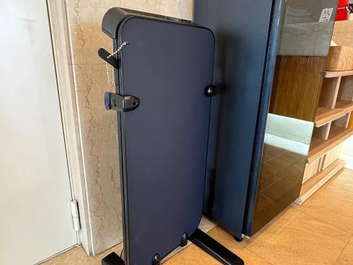 a refrigerator is standing next to a door at Z hotel in Ueda