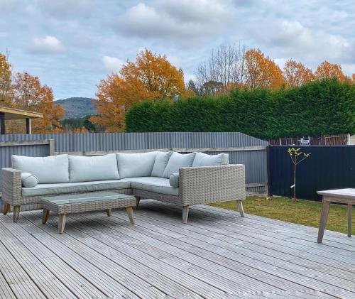 a couch and a table on a patio at Vida in Turangi