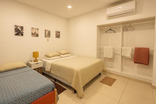 - une chambre avec 2 lits et une douche avec des serviettes dans l'établissement Acogedor dpto Zona Shoppings, à Asuncion