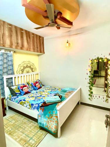 a bedroom with a bed and a ceiling fan at Villa De Dunes 369, Orchid Home in Bengaluru