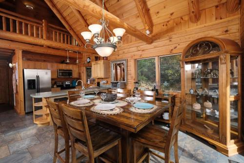 a kitchen with a large wooden table and chairs at Christines Cabin 1101 in Gatlinburg