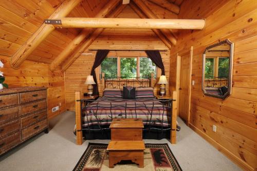 a bedroom with a bed in a log cabin at Christines Cabin 1101 in Gatlinburg
