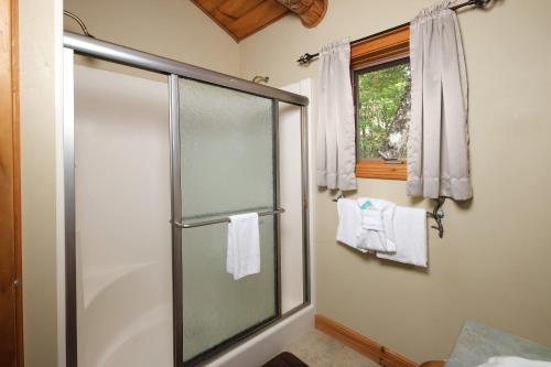 a bathroom with a shower with a glass door at Christines Cabin 1101 in Gatlinburg
