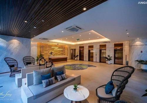 a living room with a couch and chairs at The Song Tam Thang Tower in Vung Tau
