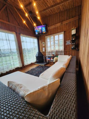 a room with several beds and a television in it at Colina Branca in Rio Rufino