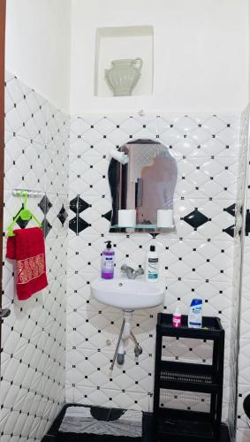 a bathroom with a sink and a mirror at Apparemment al baraka in Tangier