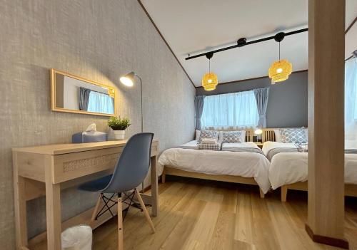 a bedroom with a desk and a bed and a desk at Villa Kyoto Uzumasa East in Sagano