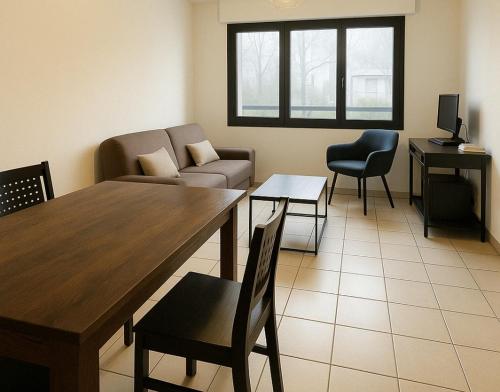 a living room with a couch and a table and chairs at Salon de Provence in Salon-de-Provence