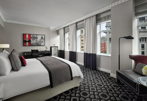 a hotel room with a bed and a chair at Sofitel Lafayette Square Washington DC in Washington
