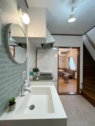 a kitchen with a sink and a mirror at Villa Kyoto Uzumasa East in Sagano