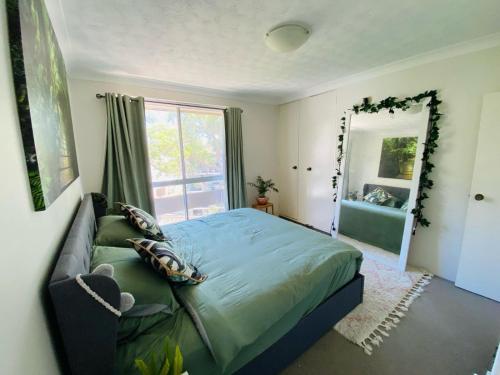 a bedroom with a bed and a large mirror at Nico's unit Two bedrooms shared in Sydney