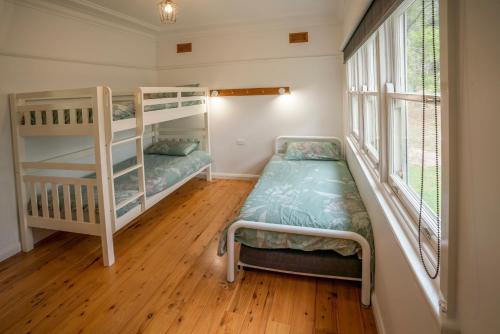 a bedroom with two bunk beds and a window at Yellow Rock in Benandarah