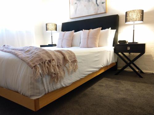 a bedroom with a large bed with white sheets and pillows at North Melbourne Retreat in Melbourne