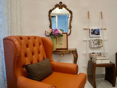 an orange chair in a room with a mirror at Melodies Moderne 2B2B Near HolidayPlaza KSL in Johor Bahru