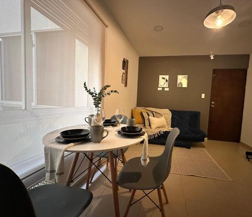 a dining table and chairs in a living room at Apartamento entero bien ubicado en zona exclusiva wifi in Popayan