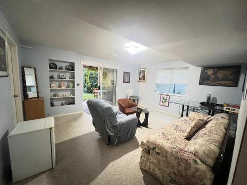 a living room with a couch and a chair at Fraser Valley Getaway With Breakfast S-5 in Abbotsford