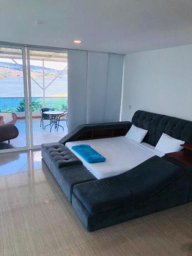 a large bed in a room with a large couch at Hotel Blue Palace in Calima