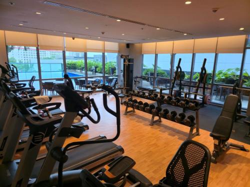 a gym with treadmills and elliptical machines at Resort-style Comfort Near Mactan Airport in Punta Engaño