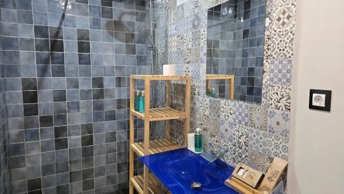 a bathroom with a blue sink and a shower at Felix Saenz Boutiques Suites by Del Parque Flats in Málaga