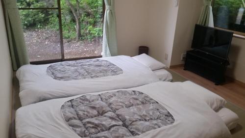 Postel nebo postele na pokoji v ubytování Nishimiyasou