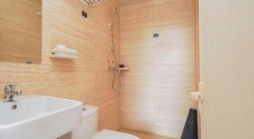 a bathroom with a white toilet and a sink at PAI Hotels Shijiazhuang Railway Station West Square in Shijiazhuang