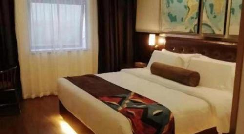 a bedroom with a large white bed with a window at James Joyce Coffetel Guilin Railway Station Xiangbi Mountain Liangjiang Sihu Wharf in Guilin