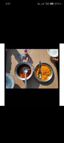 a table with three plates of food on it at Ranfamily home stay in Dhordo