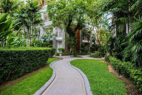 a walkway through a garden in front of a building at Beachfront 120sqm 2BR with Private Plunge Pool on stunning Naithon beach in Nai Thon Beach