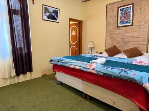 a bedroom with a large bed in a room at Apple Grove in Saturang