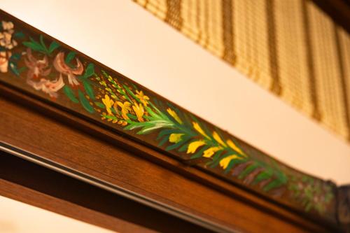 a wooden drawer with flowers painted on it at Kyotoya in Takeo