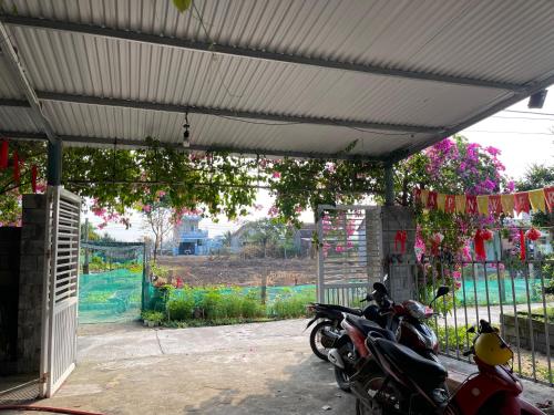 a group of motorcycles parked under a canopy at Khu Nghỉ Dưỡng Thuần Chay MIND LINK 