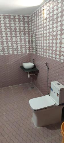 a bathroom with a toilet and a sink at Barkha Desert Safari Camp Sam Sand Dunes Jaisalmer in Sām
