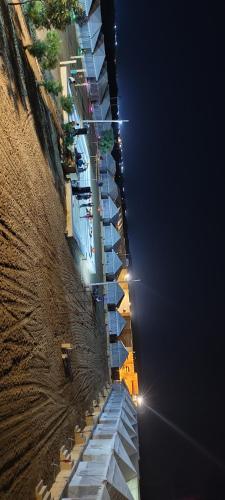 a building with lights on the side of it at night at Barkha Desert Safari Camp Sam Sand Dunes Jaisalmer in Sām
