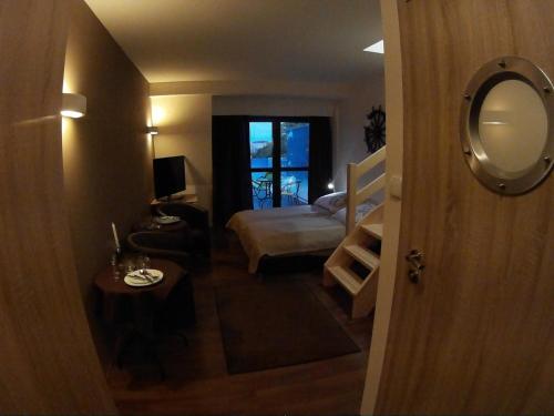 a small room with a bed and a mirror at Dolphin House in Łeba