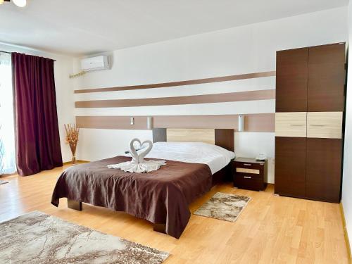 a bedroom with a bed with a towel on it at Casa Verde in Orşova