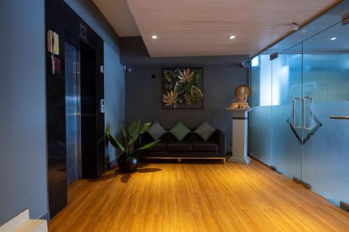 a living room with a black couch and blue walls at Thilhara Colombo in Colombo