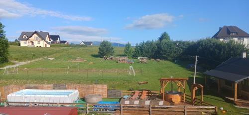 a view of a large field with a playground at amel orawa in Podwilk
