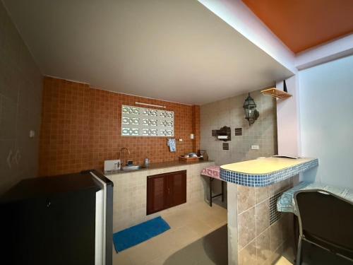 a small kitchen with a sink and a counter at Sawasdee House in Lamai