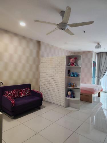 a living room with a couch and a bed at Cozy Stay - Atria Sofo in Damansara Jaya in Petaling Jaya